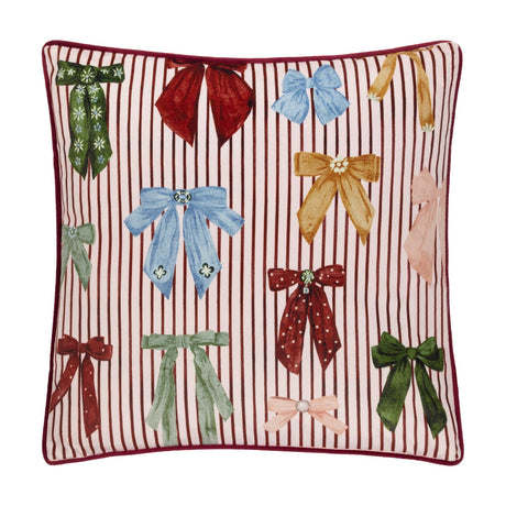 Noortje Velvet Silk Cushion in Silk Pink, a square velvet cushion with pink and burgundy stripes, printed multicoloured bows, and a burgundy piped edge.