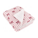Folded Noortje Bows Silk Throw in pink, with red striped bow print on the face and sherpa fleece reverse visible, shown on a white background.