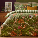 Nya Woodland Reversible Striped Duvet Cover Set in forest green, featuring foxes, hares, deer and owl print, styled on a bed with striped pillowcases in a bedroom setting.
