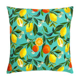 Square polyester cushion in turquoise with a printed pattern of lemons, oranges and orange blossom among green leaves, shown on a plain white background.