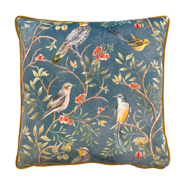 Orient Animal Velvet Cushion in slate blue, square with gold piping, featuring a chinoiserie print of five perched birds among branches and pink blossom on a plain background.