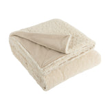Olann Plain Velvet Throw in Natural, folded to show its shearling-look faux fleece front and smooth velvet reverse, shown on a plain white background.