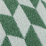 Close-up of the Olsen Geometric Polyester Cushion in Good For You Green, showing bottle-green and mint diamond blocks on a soft, knitted feather-yarn pile.