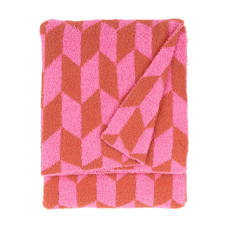 Olsen Geometric Polyester Throw in Pink Pop, folded to show a bold chevron pattern in pink and rust with a plush knitted pile, against a plain white background.