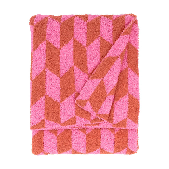 Olsen Geometric Polyester Throw in Pink Pop, folded to show a bold chevron pattern in pink and rust with a plush knitted pile, against a plain white background.