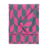 Olsen Geometric Polyester Throw in Retro Pink, folded to show a bright pink and teal chevron pattern, textured knit fabric, shown on a plain white background.