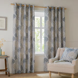 Ophelia Jacquard Fully Lined Eyelet Curtains in Wedgewood, floral tree pattern in slate blue and taupe on pale ground, shown framing a window in a living room setting.