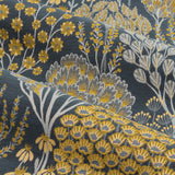 Close-up of Ophelia Jacquard Pencil Pleat Curtains fabric, showing a woven floral and botanical pattern in saffron gold and grey tones on a deep teal-blue polyester ground.