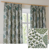 Ophelia Jacquard pencil pleat curtains in Thyme/Mineral, hung on a wooden pole beside a window, featuring a green and blue-grey botanical tree and floral pattern on cream, with a fabric swatch inset.