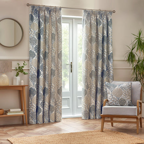 Ophelia Jacquard Polyester Pencil Pleat Curtains in Wedgewood blue and beige botanical print, hung on a pole either side of French doors in a living room.