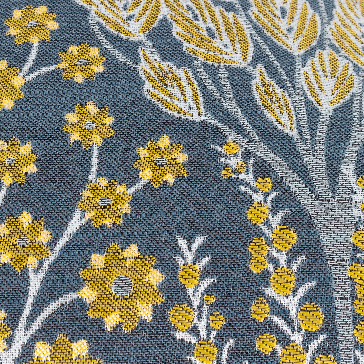 Close-up of the Ophelia Jacquard Polyester Cushion in blue, showing a woven botanical pattern with saffron flowers, seed heads and cream leaf sprays in a raised jacquard texture.