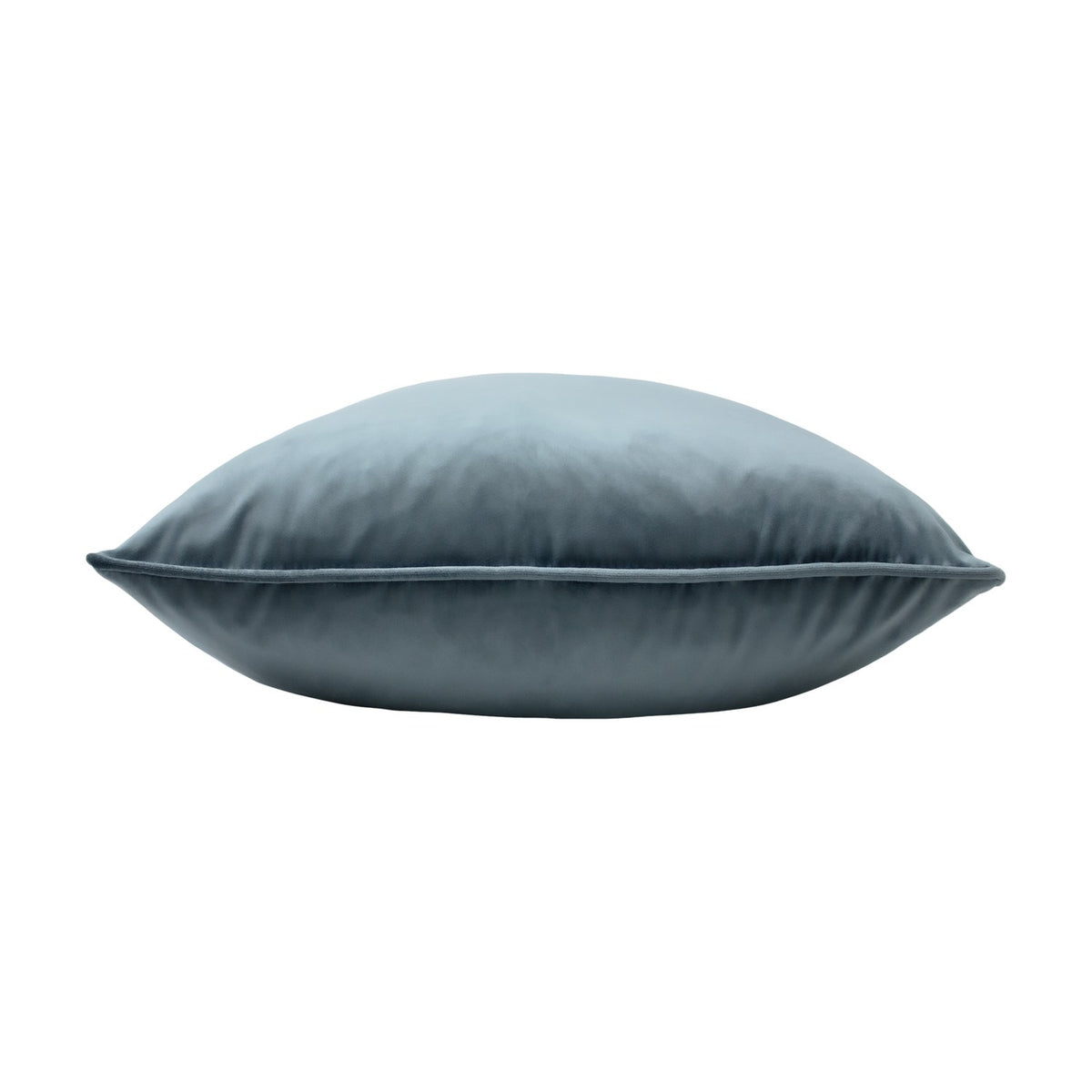 Opulence Plain Velvet Cushion in petrol blue, shown side-on with a plump square shape and piped edge trim, set against a plain white background.