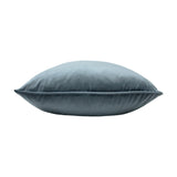 Opulence Plain Velvet Cushion in petrol blue, shown side-on with a plump square shape and piped edge trim, set against a plain white background.