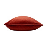 Opulence Plain Velvet Cushion in Sunset rust-orange, shown side-on with piped edge detail and plump velvet pile, against a plain white background.