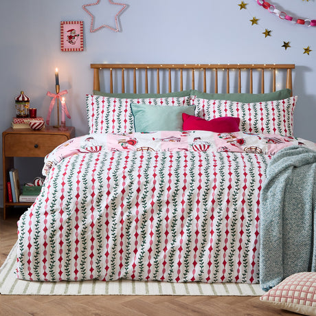 Passport To The North Pole striped duvet cover set on a bed, showing the red and pink mistletoe stripe design with pillowcases in a festive bedroom setting.