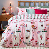 Passport To The North Pole Striped Duvet Cover Set in Candy Floss/Linen on a bed, featuring pink and cream stripes with Santa scenes, styled with green and pink cushions in a festive bedroom.