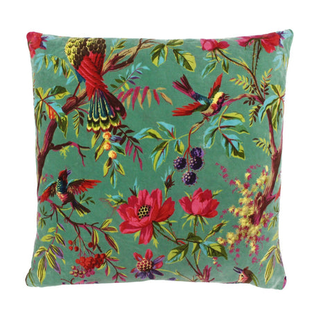 Paradise Velvet Cotton Cushion in aqua, square with birds, blooms, berries and foliage printed in reds, pinks and greens on a soft blue-green velvet ground, shown on a white background.