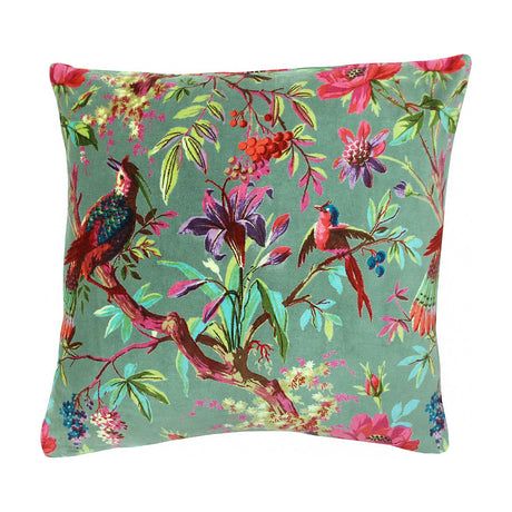 Paradise Velvet Cotton Cushion in Mineral, a square green cotton velvet cushion printed with perched birds, lilies and branches in red, teal and coral, shown on a white background.