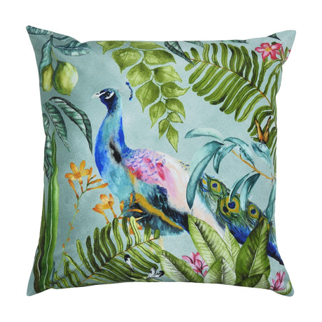 Peacock Animal Polyester Cushion in multi, square with a blue-teal peacock among green foliage and pink flowers on a duck-egg background, shown on a plain white background.