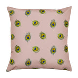 Square polyester cushion in dusky pink featuring a scattered peacock-feather print in green, gold and blue, shown on a plain white background.