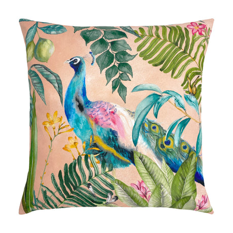 Peacock Animal Polyester Cushion in blush pink, printed with a teal and blue peacock amid green tropical leaves and yellow flowers, shown on a plain white background.