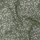 Perrie Leaf Floral Polyester Curtain Panel in forest green, close-up of sheer fabric with trailing white leaf sprigs printed across the lightweight woven texture.