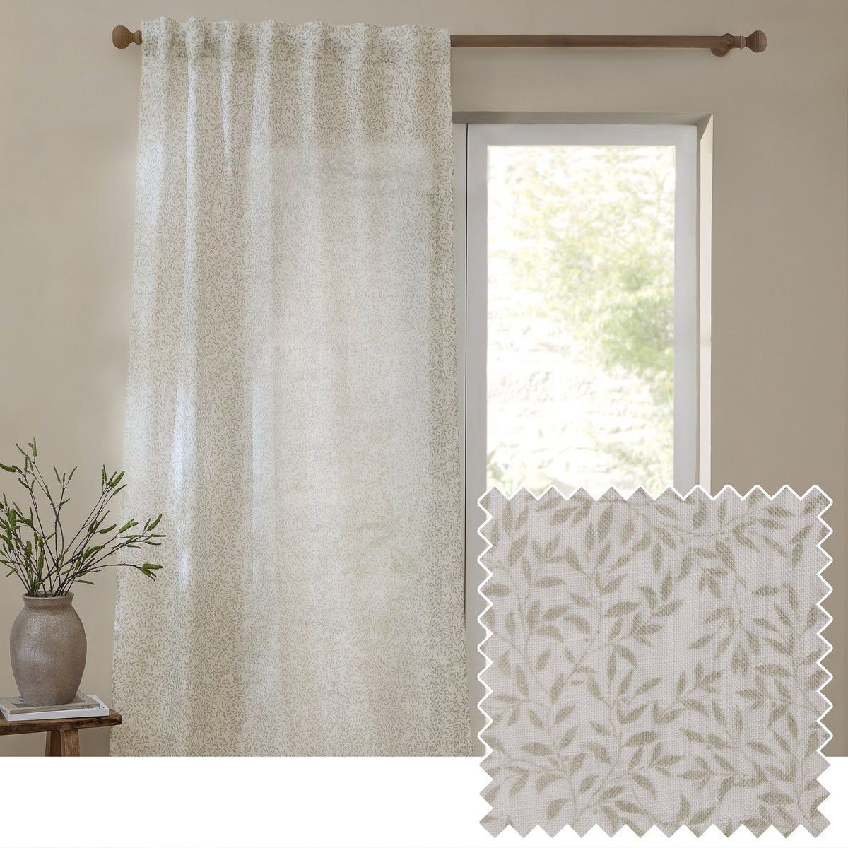 Perrie Leaf Floral Polyester Curtain Panel in natural, semi-sheer fabric with trailing leaf print, shown hanging by a window beside a fabric swatch and leafy vase in a neutral room.