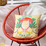 Pina There Abstract Polyester Cushion in yellow on an orange rattan chair, featuring a pina colada design with tropical leaves, pineapples and "Pina There Drank That" slogan.