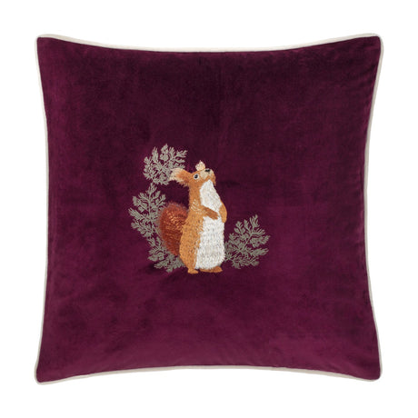 Pineberry Forest Animal Velvet Cushion in plum, featuring an embroidered red squirrel amid grey-green foliage on a square velvet cushion with cream piping, shown on a white background.
