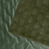 Pines Velvet Faux Fur Throw in forest green, showing raised tufted tree pattern on one side and plain smooth velvet reverse, folded corner detail.