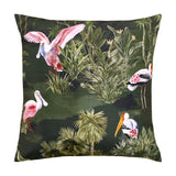 Platalea Jungle Polyester Cushion in Bottle Green, a 43 x 43cm square cover featuring pink spoonbills and painted storks among palms on a dark green ground, shown on a white background.