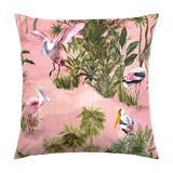 Platalea Jungle Polyester Cushion in Blush, a square scatter cushion printed with wading spoonbills and storks among palms and tropical foliage on a pink ground, shown on a plain white background.