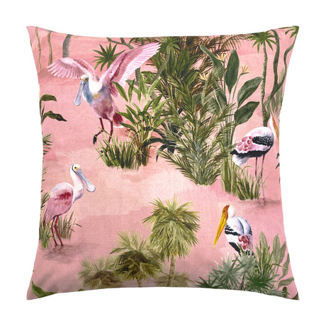 Platalea Jungle Polyester Cushion in Blush, a square scatter cushion printed with wading spoonbills and storks among palms and tropical foliage on a pink ground, shown on a plain white background.