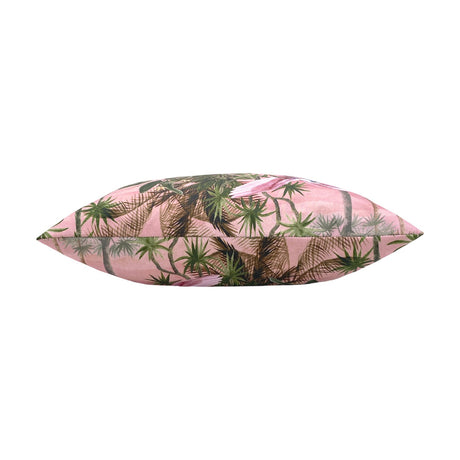 Platalea Jungle polyester cushion in Blush, shown side-on to reveal its plump piped edge printed with palms and wading birds on pink, set against a white background.