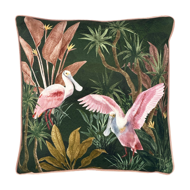 Platalea Botanical Velvet Cushion in green, printed with two pink spoonbills among tropical palms and banana leaves, pink piped edge, square 43 x 43cm design on a white background.
