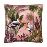 Platalea Botanical Velvet Cushion in pink, square with piped edge, featuring a painted scene of two Spoonbill birds among palms and jungle leaves on a blush ground, shown on a white background.