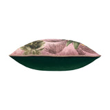 Platalea Botanical Velvet Cushion in pink, shown side-on with tropical leaf print piped edge and plain green velvet reverse, on a white background.
