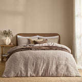 Perrie Leaf Cotton Ditsy Duvet Cover Set in chocolate brown with cream leaf print, styled on a bed with matching pillowcases and a brown throw in a bedroom setting.