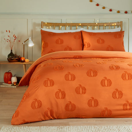Pumpkin Fields Tufted Plain Duvet Cover Set in orange, shown on a bed with matching pillowcases featuring a raised tufted pumpkin motif, styled in a bedroom with autumnal decor.