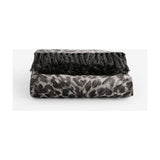 Pokot Animal Velvet Throw in monochrome, folded to show leopard-print grey and black velvet with knotted black fringe trim, on a plain white background.