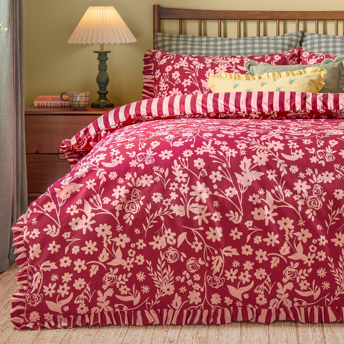 Posie Reversible Floral Duvet Cover Set in Berry, styled on a bed with a ruffled edge, floral pink-on-berry print, and matching pillowcases in a bedroom setting.
