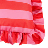 Close-up of the Palm Royale Stripe cushion in pink and red vertical stripes, showing the gathered ruffle trim continuing the striped pattern around the edge.