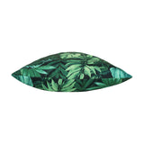 Side view of the Psychedelic Jungle Reversible Polyester Cushion, showing a dense tropical leaf print in green and blue-green tones on a near-black ground, photographed on a plain white background.
