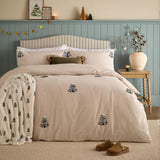 Pine Tree Cotton Woodland Duvet Cover Set in natural, styled on a bed with tufted pine tree motifs and pale dot detailing, shown in a bedroom with matching pillowcases and a coordinating throw.
