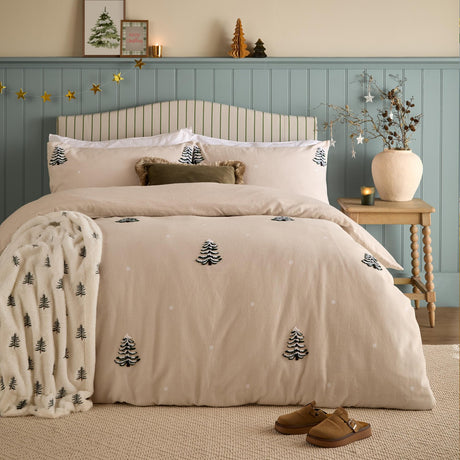 Pine Tree Cotton Woodland Duvet Cover Set in natural, styled on a bed with tufted pine tree motifs and pale dot detailing, shown in a bedroom with matching pillowcases and a coordinating throw.