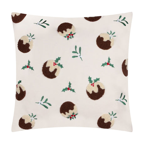 Square cream velvet cushion with tufted Christmas pudding motifs in brown and cream, accented by embroidered holly, mistletoe, and red berries, shown on a white background.