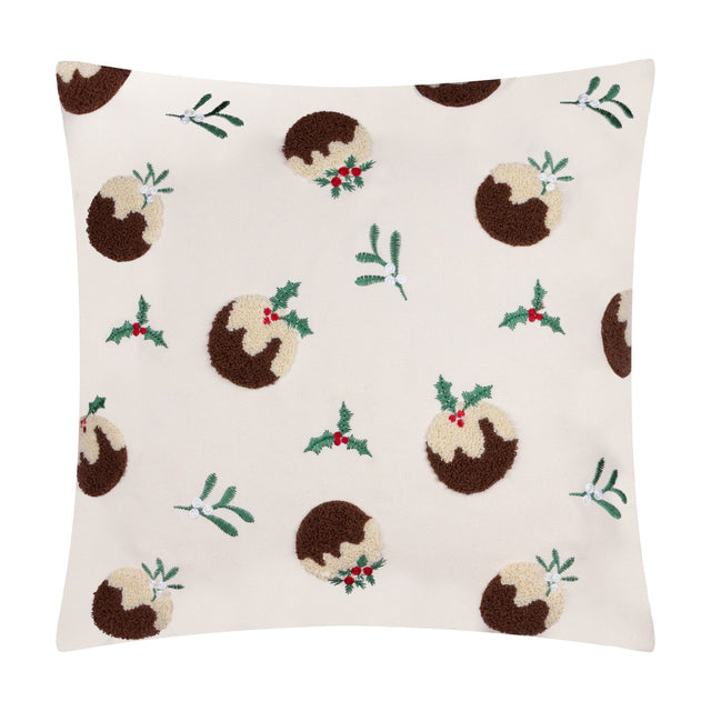 Square cream velvet cushion with tufted Christmas pudding motifs in brown and cream, accented by embroidered holly, mistletoe, and red berries, shown on a white background.