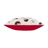 Side view of the Puddings Velvet Cotton Cushion showing cream velvet front with tufted Christmas pudding motifs and holly sprigs, paired with a plain red velvet reverse, on a white background.