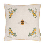 Square natural linen cushion with a tufted bee at the centre and embroidered yellow floral sprays in each corner, edged with yellow gingham piping, on a plain white background.