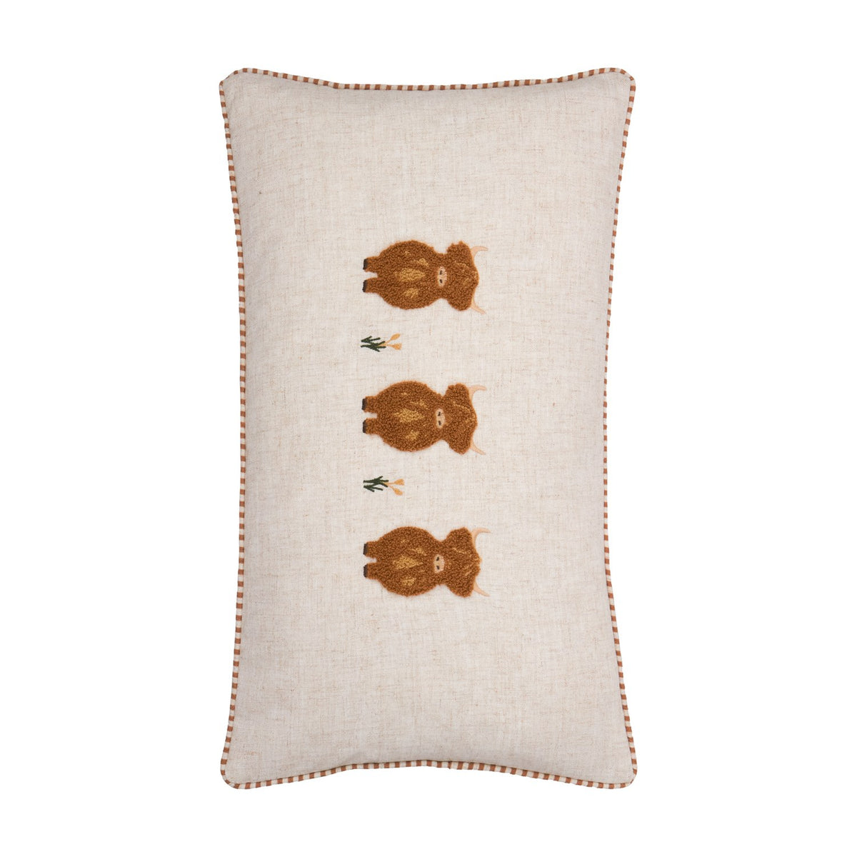 Rectangular linen cushion in oatmeal with three tufted rust-brown highland cows in a vertical row, embroidered grass tufts between them, and gingham piped edging on a plain white background.